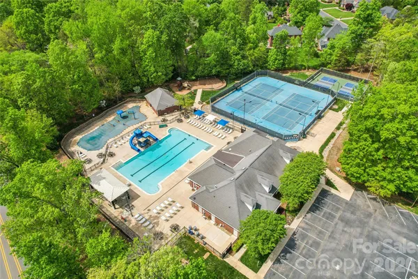 a view of a swimming pool with a patio and a garden