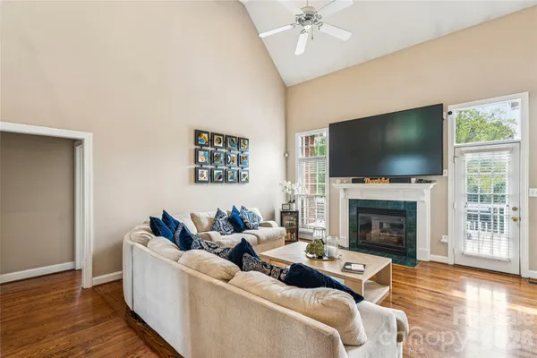 a living room with furniture a fireplace and a flat screen tv