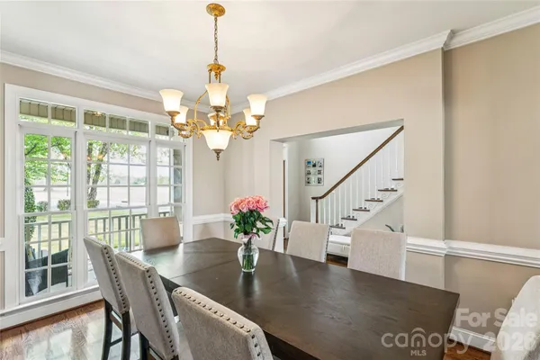 a view of a dining room with furniture wooden floor and chandelier