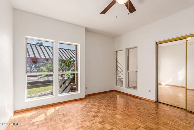 a view of an empty room with window and cabinet