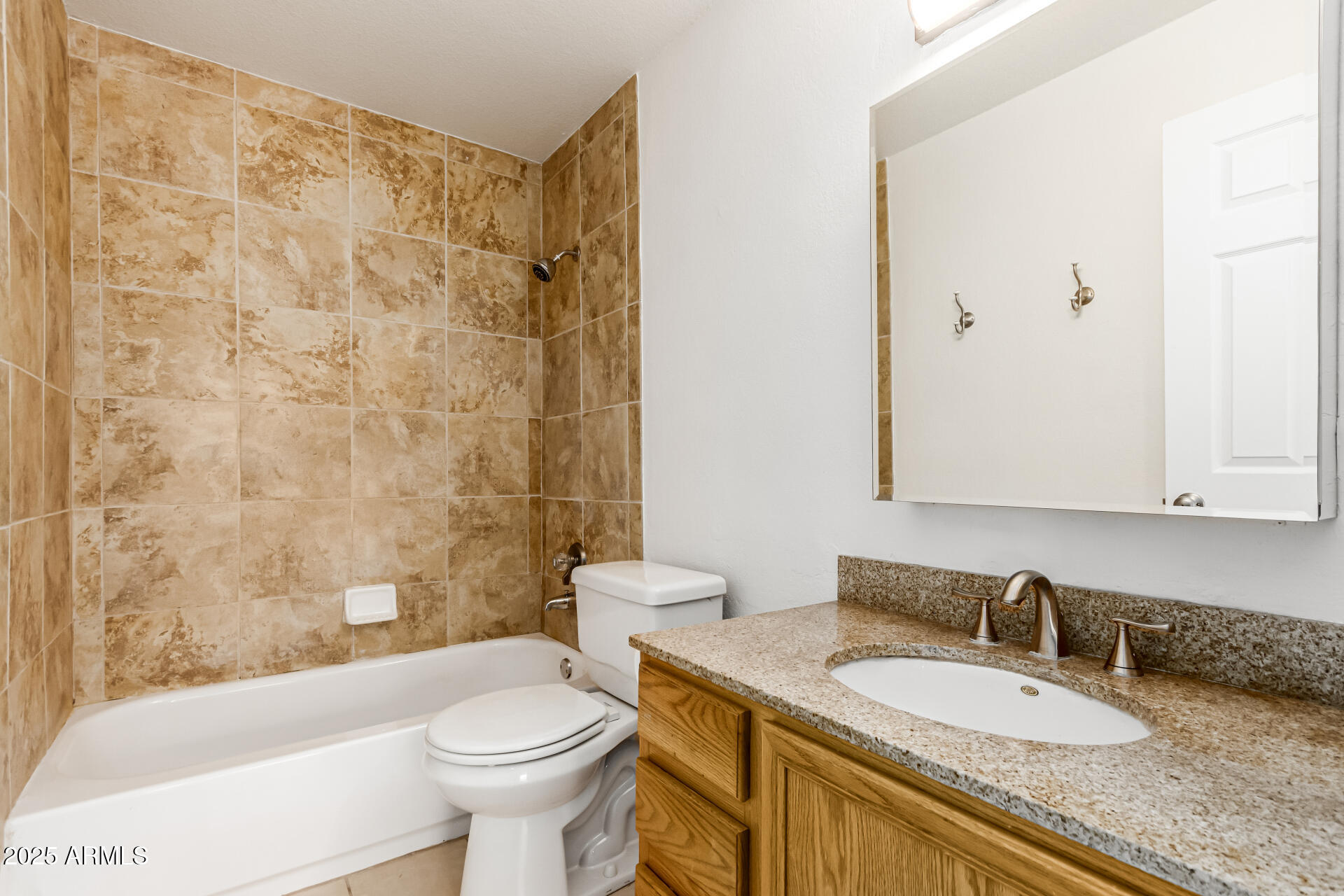 101 North 7th Street, Unit 135 Phoenix, AZ 85034 - Photo 16 of 33 a bathroom with a granite countertop bathtub sink mirror vanity and toilet