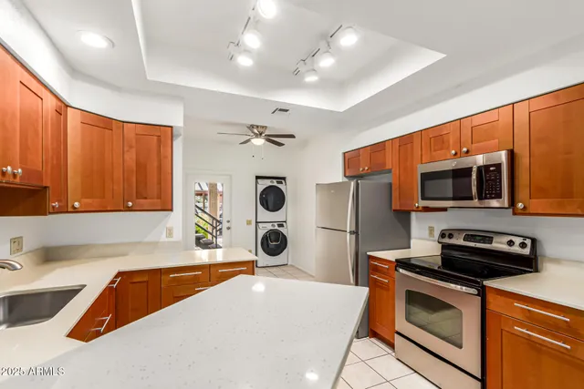 a kitchen with stainless steel appliances a stove a sink and a microwave