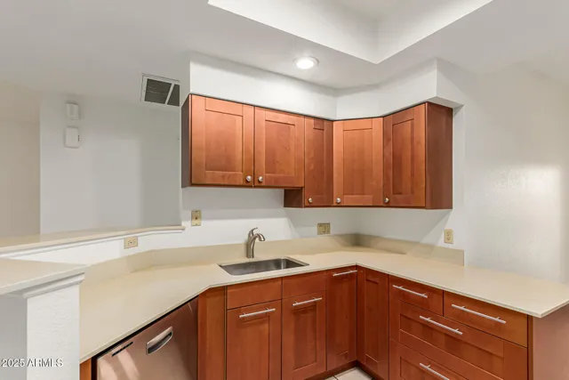 a kitchen with a sink cabinets and window