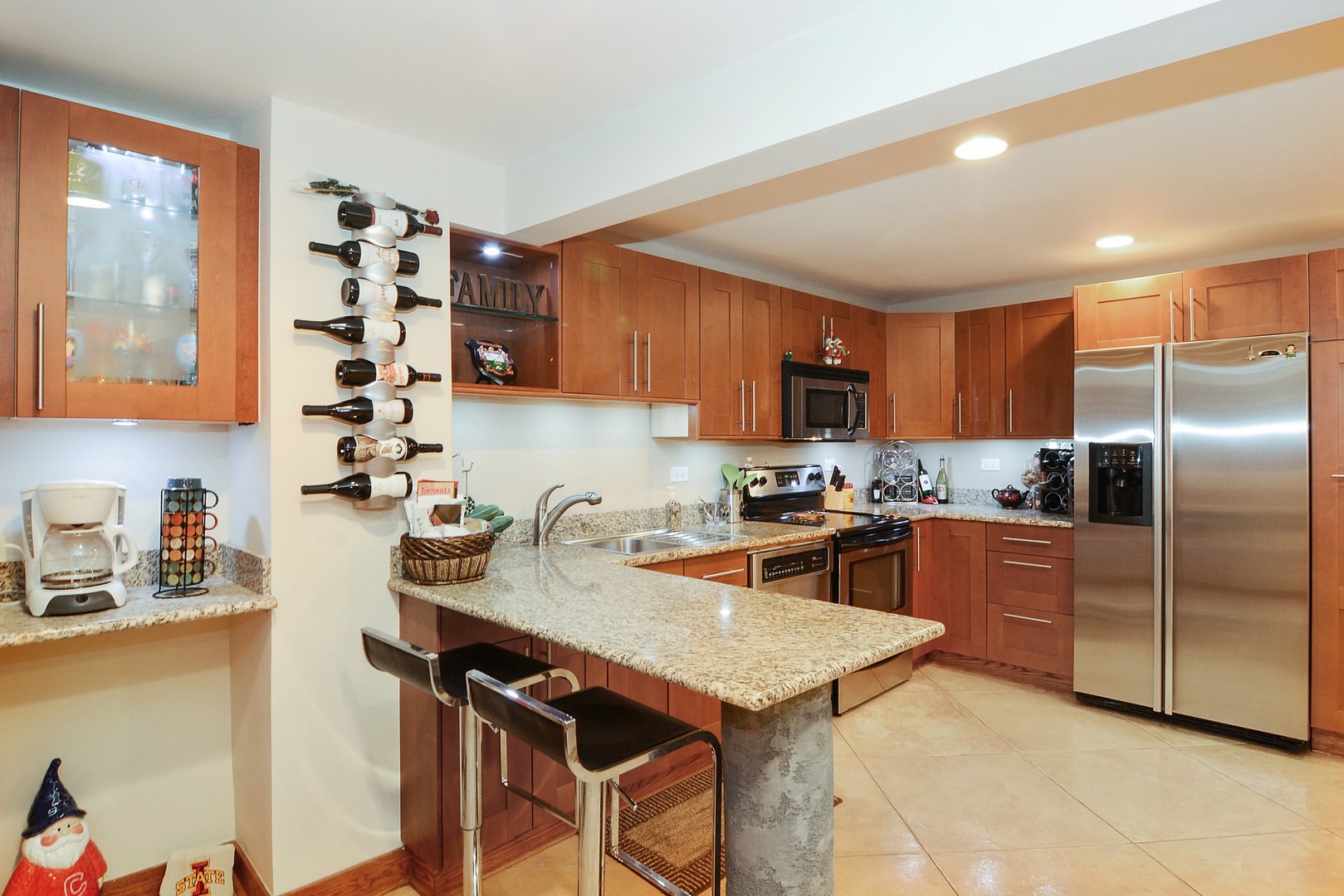 852 West Barry Avenue, Unit G Chicago, IL 60657 - Photo 6 of 13 a kitchen with granite countertop a sink stainless steel appliances and cabinets