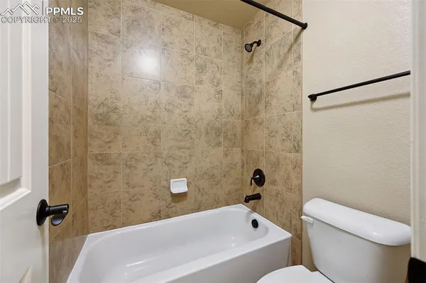 a bathroom with a toilet and a bathtub