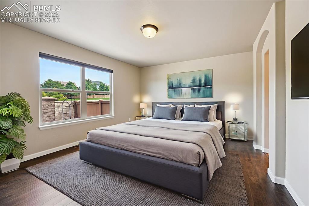 5384 Oak Spring Heights Colorado Springs, CO 80923 - Photo 7 of 19 a spacious bedroom with a bed and a window