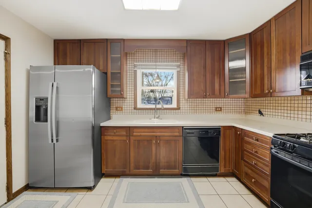 a kitchen with stainless steel appliances granite countertop a refrigerator and a sink