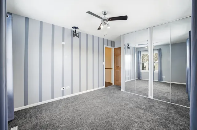 a view of a hallway with wooden shelves