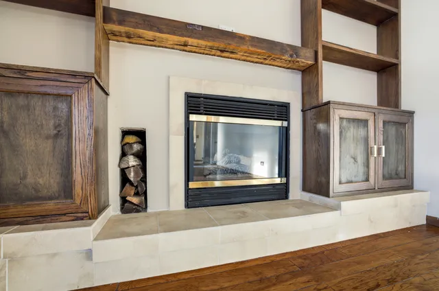 a view of a living room with a wooden floor and a fireplace