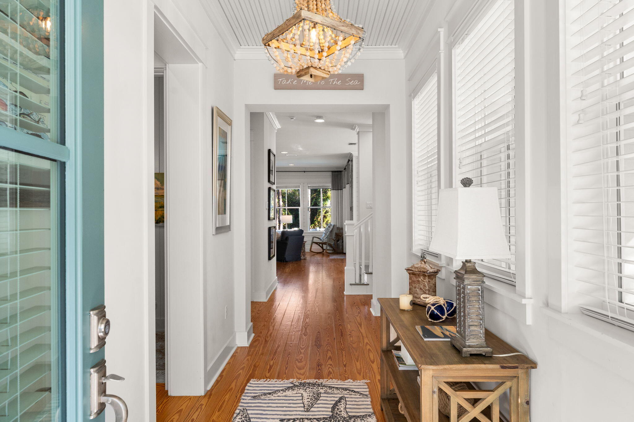 384 East Royal Fern Way Santa Rosa Beach, FL 32459 - Photo 12 of 63 a view of a hallway to a livingroom with furniture and wooden floor