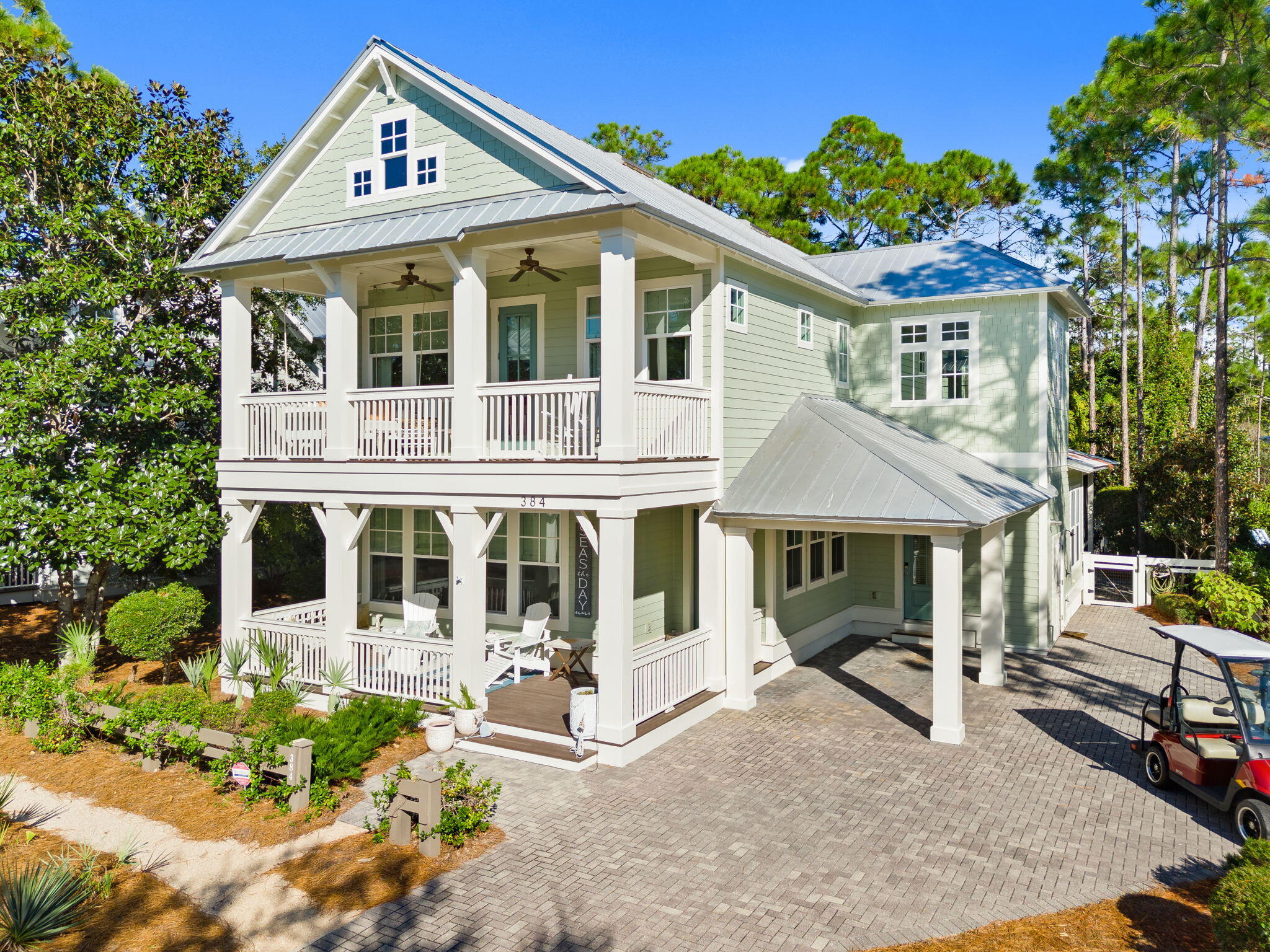 384 East Royal Fern Way Santa Rosa Beach, FL 32459 - Photo 4 of 63 a view of a white house with large windows and plants