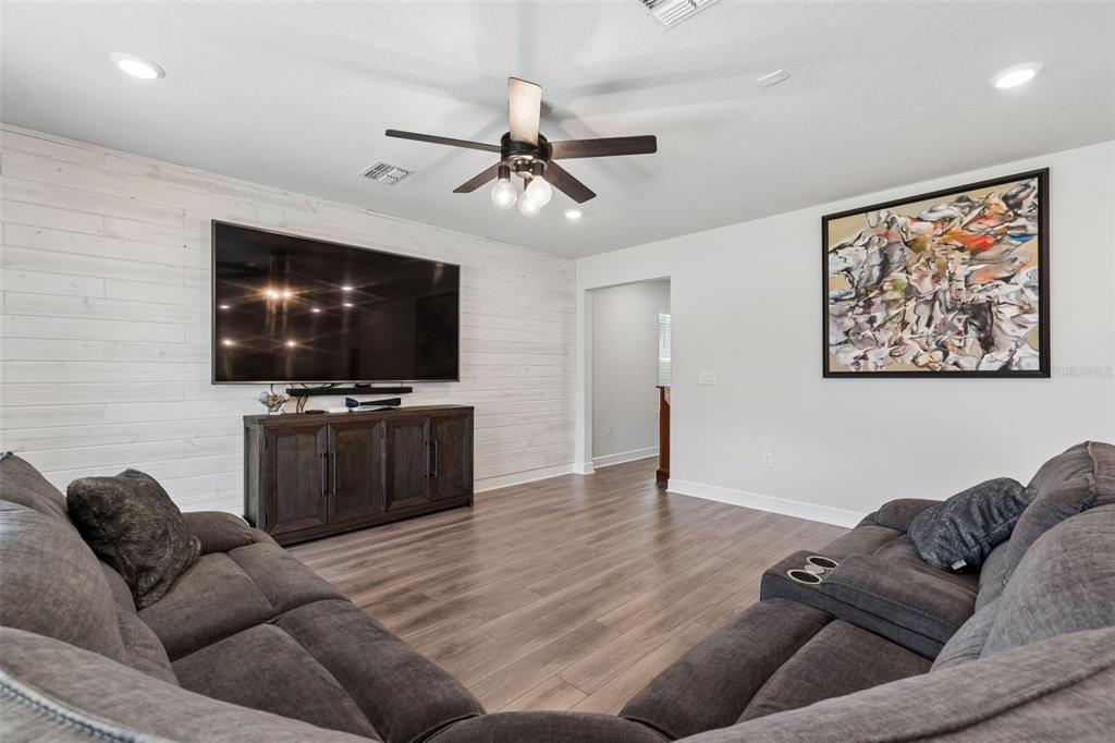6608 Ryestone Way Wesley Chapel, FL 33545 - Photo 13 of 66 a living room with furniture and a flat screen tv