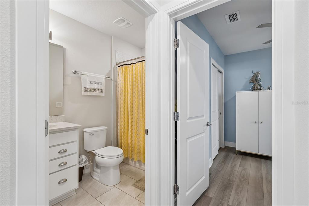 6608 Ryestone Way Wesley Chapel, FL 33545 - Photo 19 of 66 a bathroom with a granite countertop toilet a sink a mirror and a shower