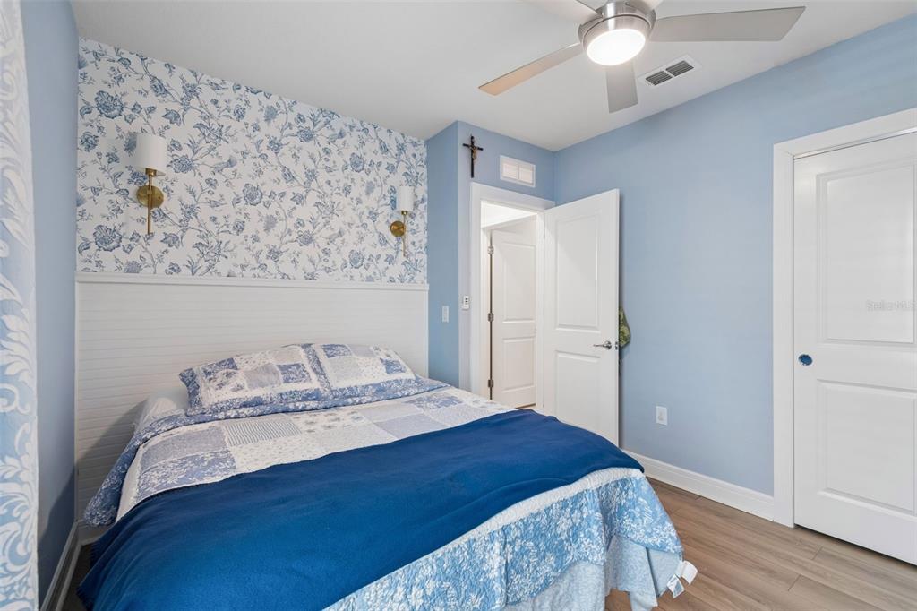 6608 Ryestone Way Wesley Chapel, FL 33545 - Photo 20 of 66 a bedroom with a bed and a chandelier