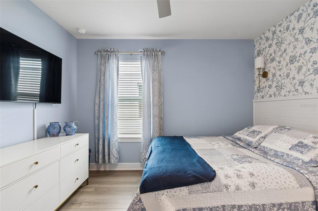 6608 Ryestone Way Wesley Chapel, FL 33545 - Photo 21 of 66 a bedroom with a large bed and a flat screen tv