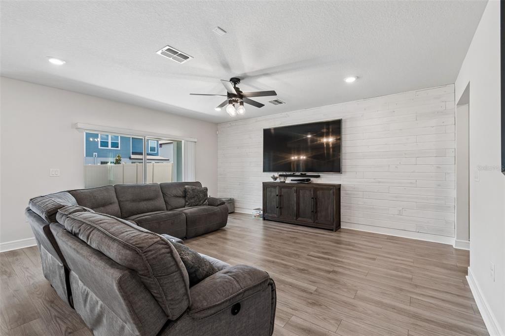 6608 Ryestone Way Wesley Chapel, FL 33545 - Photo 22 of 66 a living room with furniture and a flat screen tv