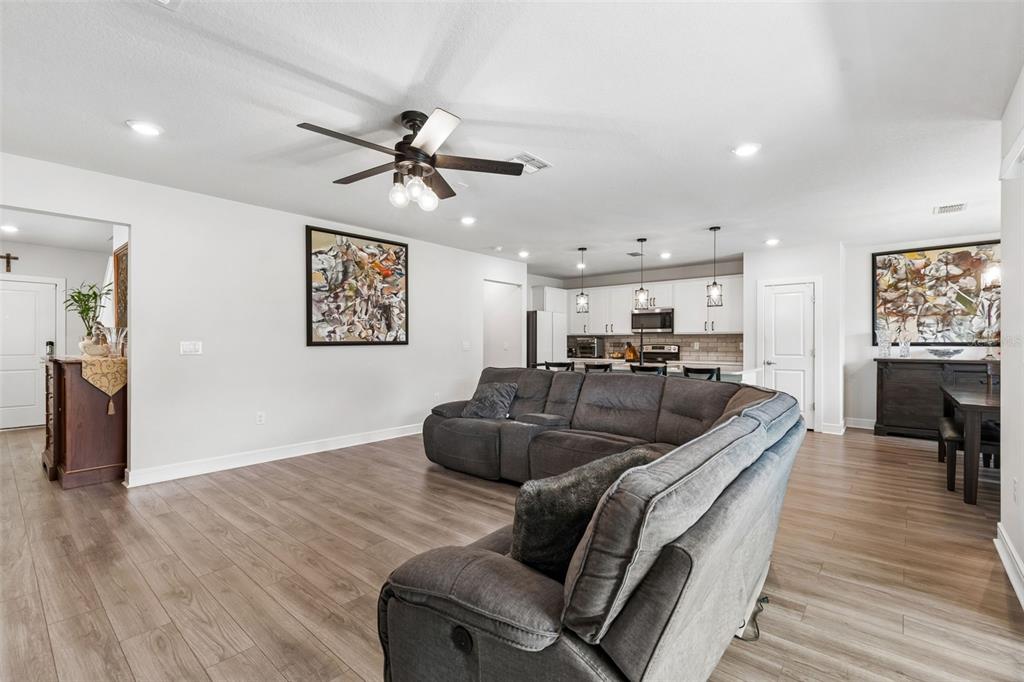 6608 Ryestone Way Wesley Chapel, FL 33545 - Photo 23 of 66 a living room with furniture and a wooden floor