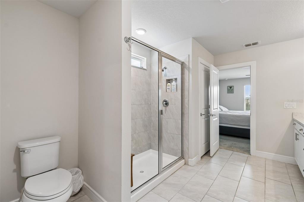 6608 Ryestone Way Wesley Chapel, FL 33545 - Photo 44 of 66 a bathroom with a toilet a sink and shower