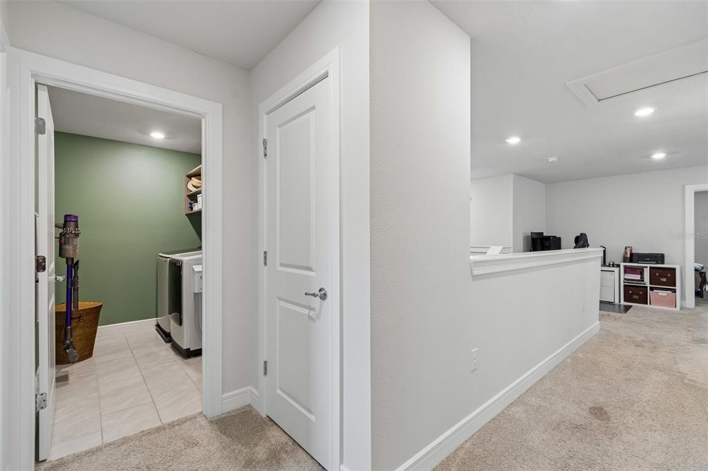 6608 Ryestone Way Wesley Chapel, FL 33545 - Photo 49 of 66 a view of a hallway and a livingroom and a bathroom