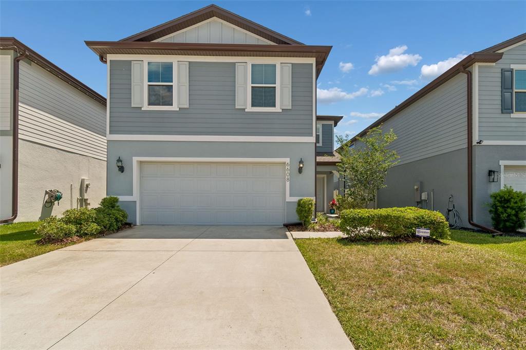 6608 Ryestone Way Wesley Chapel, FL 33545 - Photo 52 of 66 a front view of a house with a yard and garage