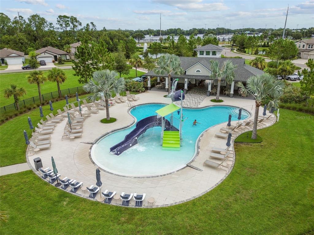 6608 Ryestone Way Wesley Chapel, FL 33545 - Photo 59 of 66 a view of a swimming pool with outdoor seating and yard
