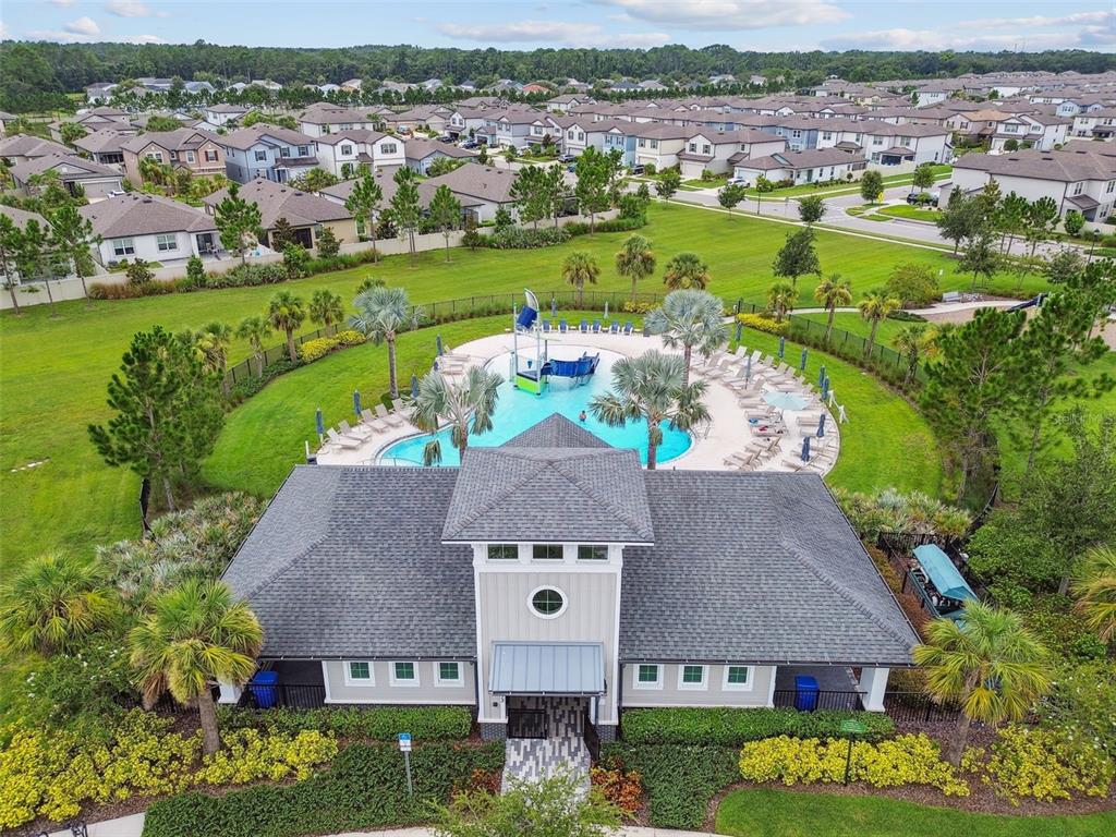 6608 Ryestone Way Wesley Chapel, FL 33545 - Photo 61 of 66 an aerial view of a house with a garden and lake view