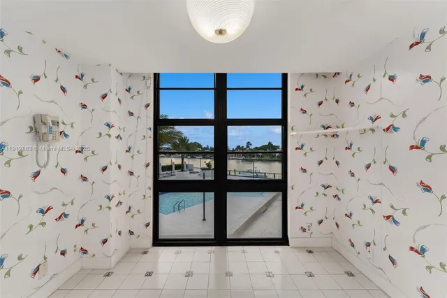 a kitchen with stainless steel appliances a sink a stove a microwave a counter top space and cabinets