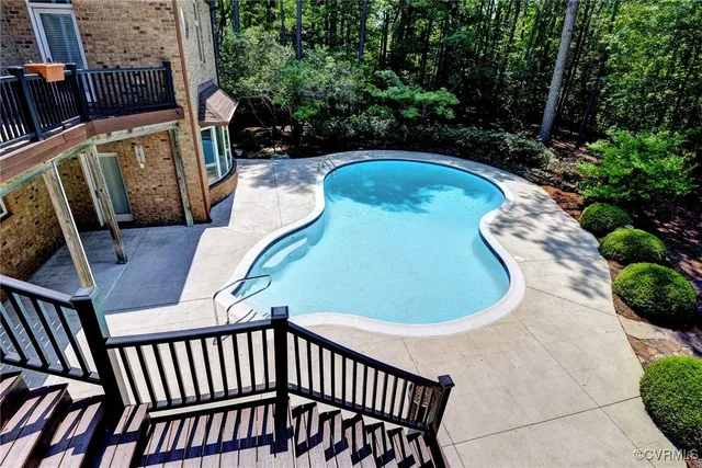 a view of balcony with wooden floor and outdoor seating