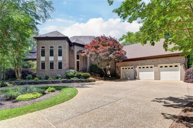 a front view of a house with a yard and trees