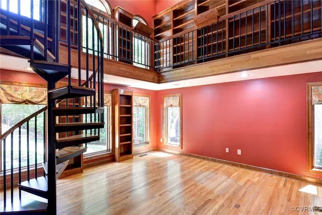 a living room with furniture fireplace and a large window