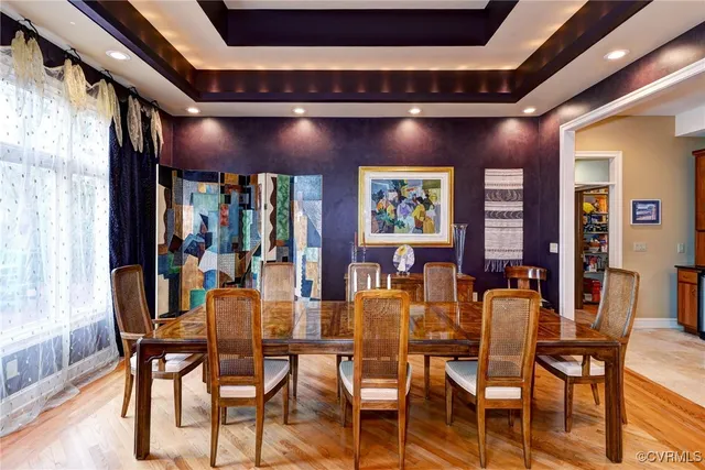 an empty room with windows fireplace and wooden floor