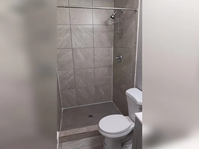 a bathroom with a toilet and a shower