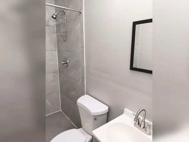 a bathroom with a toilet sink and shower