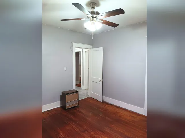 an empty room with fan and a ceiling fan