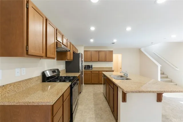 a kitchen with a sink a stove and cabinets