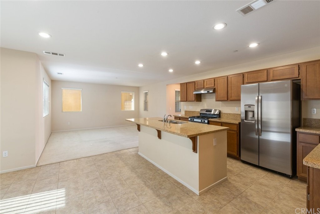 34159 Renton Drive Lake Elsinore, CA 92532 - Photo 13 of 35 a kitchen with stainless steel appliances granite countertop a refrigerator and a sink