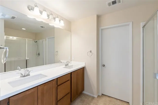 a bathroom with a double vanity sink and a mirror