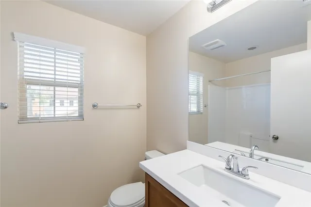 a bathroom with a sink toilet and mirror