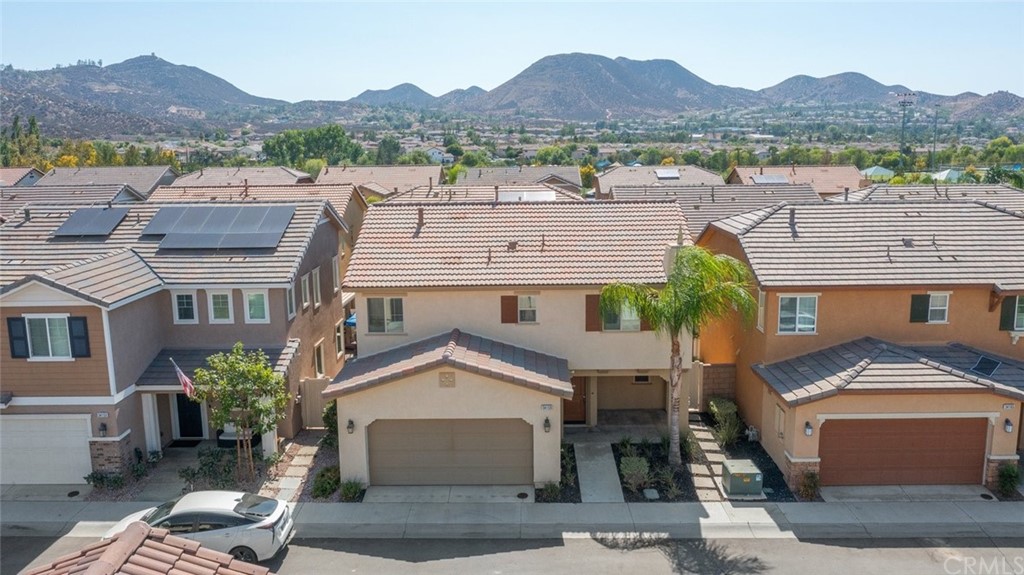 34159 Renton Drive Lake Elsinore, CA 92532 - Photo 25 of 35 a front view of a house with a yard and mountain view