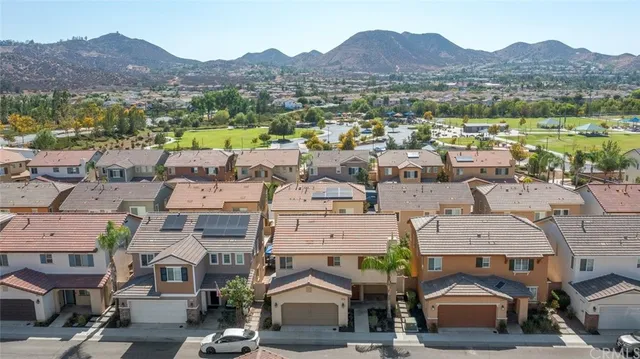 an aerial view of a house with a yard and balcony