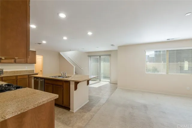 a kitchen with a stove a sink and a refrigerator