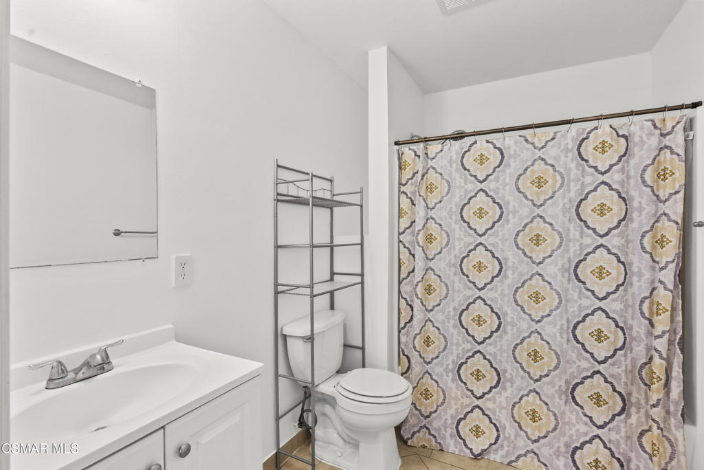 8800 Cedros Avenue, Unit 204 Panorama City, CA 91402 - Photo 6 of 11 a bathroom with a toilet sink shower and mirror