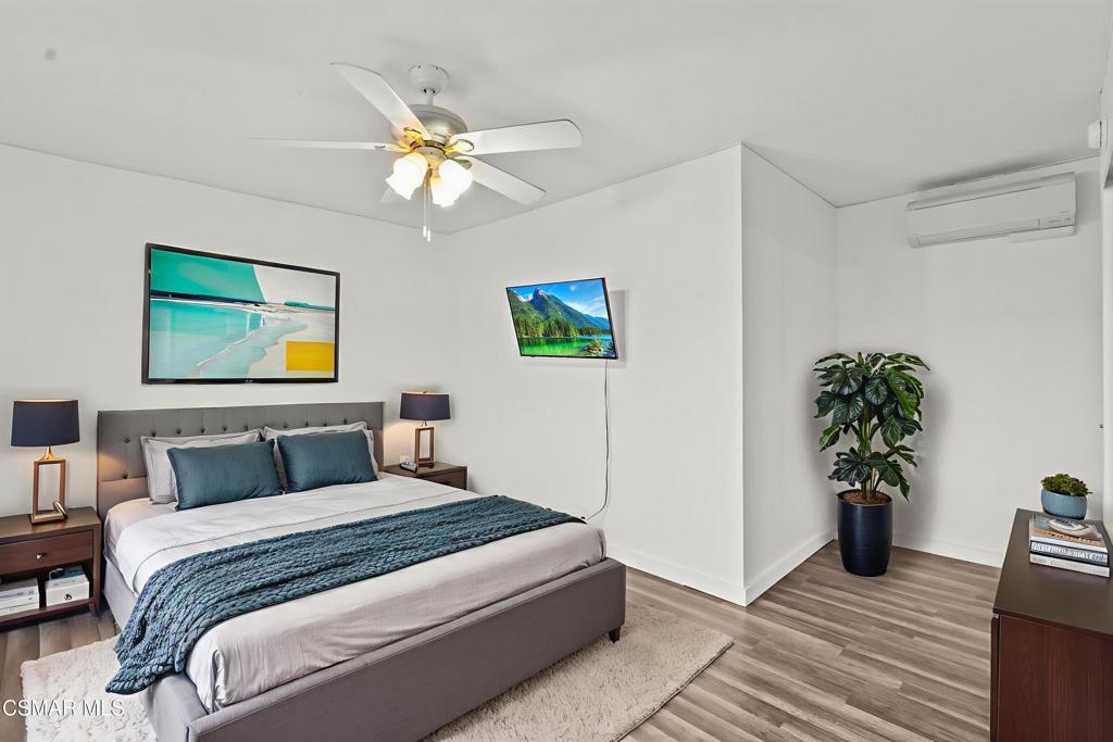 8800 Cedros Avenue, Unit 204 Panorama City, CA 91402 - Photo 7 of 11 a bedroom with a large bed and a potted plant