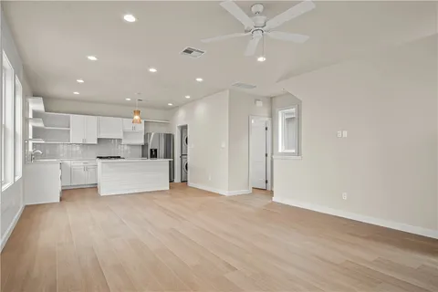 an empty room with windows and closet