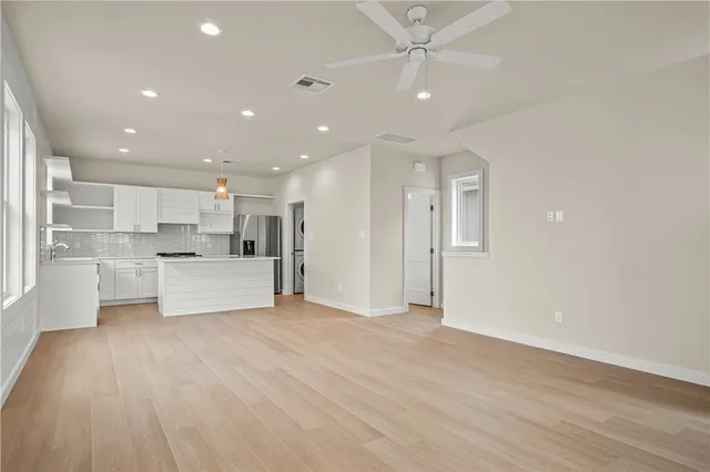 an empty room with windows and closet