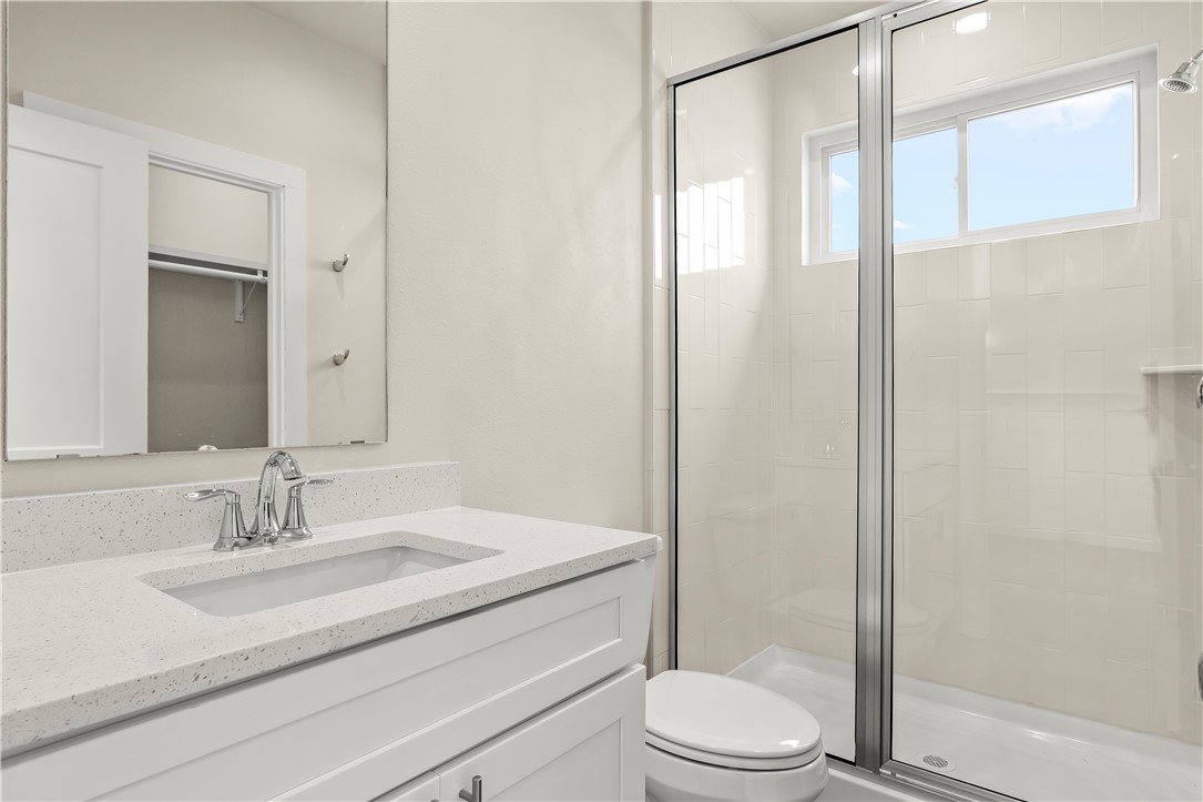 434 Oleander Street, Unit 2 Port Aransas, TX 78373 - Photo 36 of 40 a bathroom with a sink toilet and shower