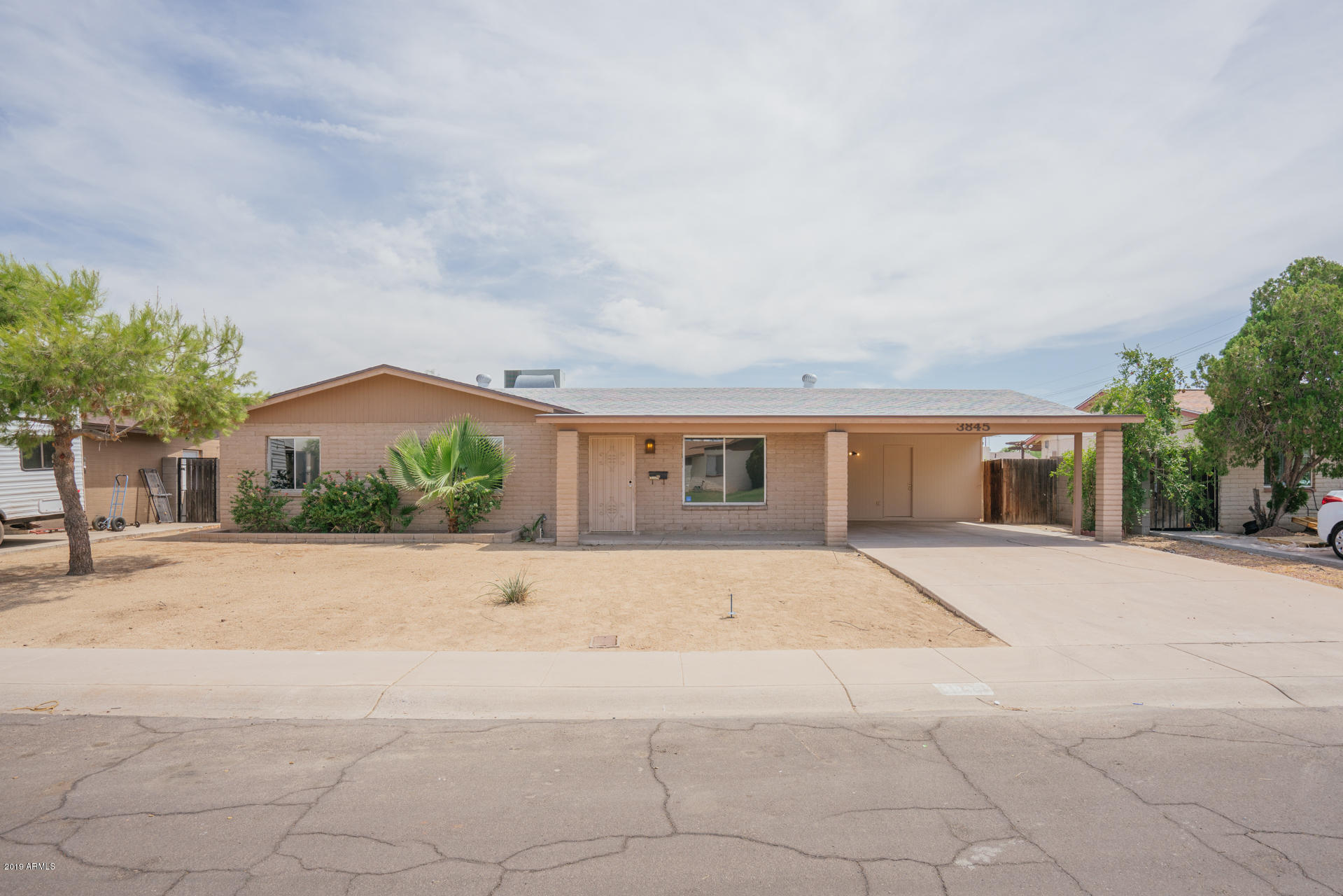 3845 West Hatcher Road Phoenix, AZ 85051 - Photo 1 of 19 a front view of house with a yard and a garage