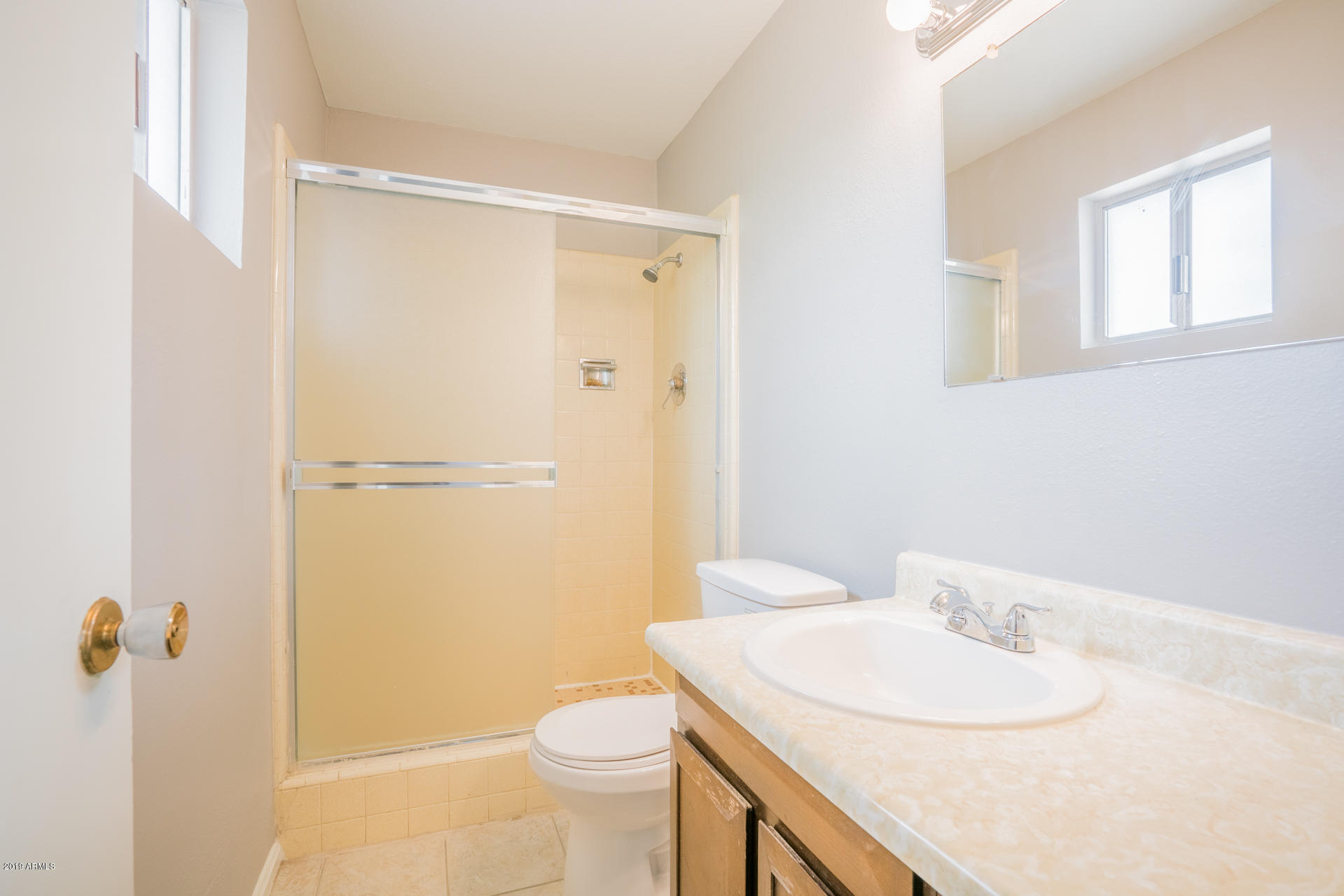 3845 West Hatcher Road Phoenix, AZ 85051 - Photo 13 of 19 a bathroom with a sink a toilet and shower