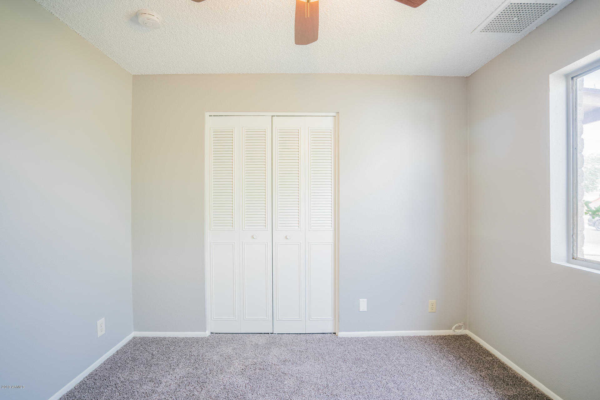 3845 West Hatcher Road Phoenix, AZ 85051 - Photo 15 of 19 an empty room with windows