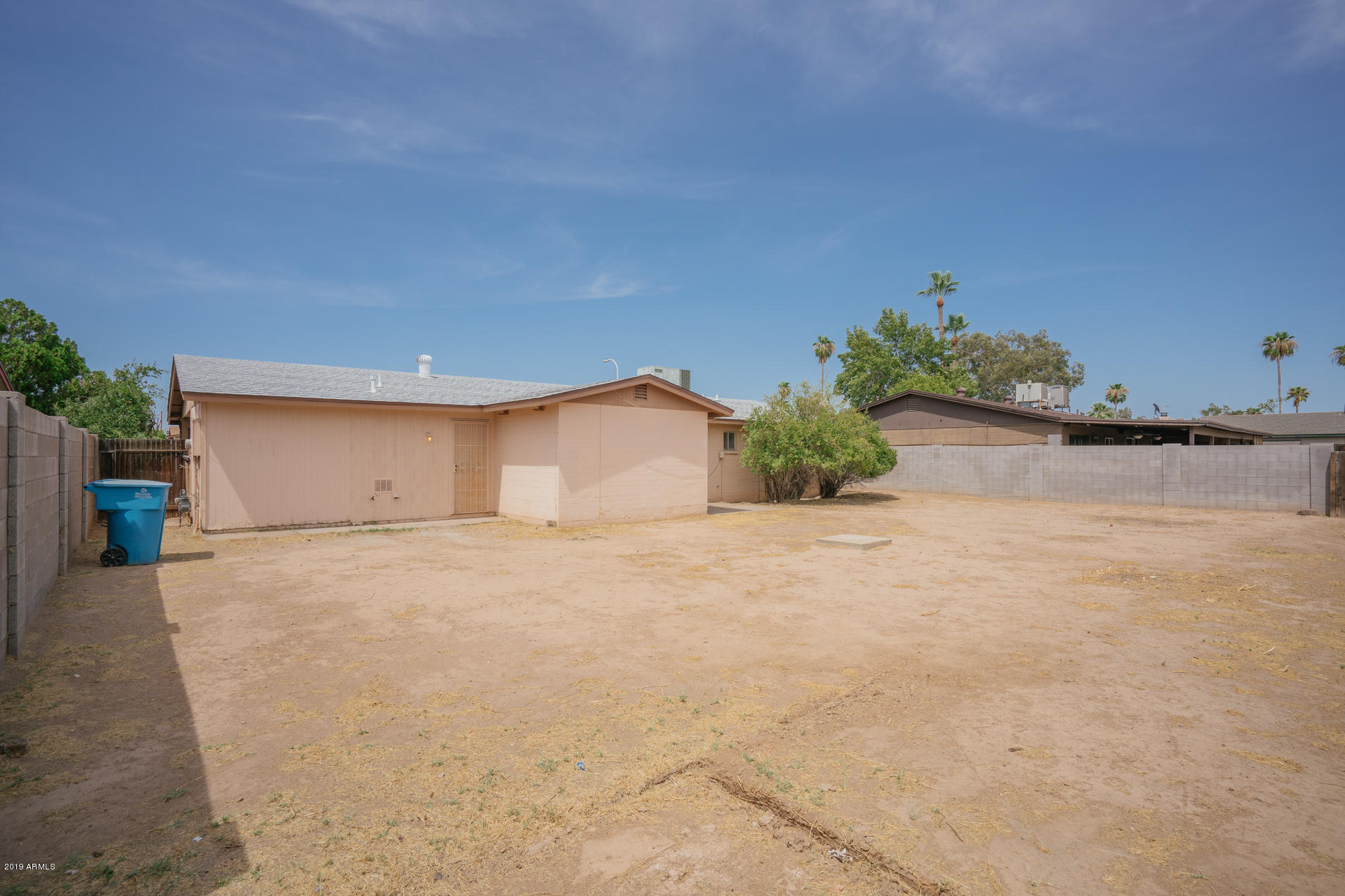 3845 West Hatcher Road Phoenix, AZ 85051 - Photo 17 of 19 a big room with potted plants and more windows